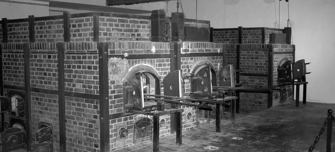 Brick-lined cremation chambers with metal doors in a crematorium facility.