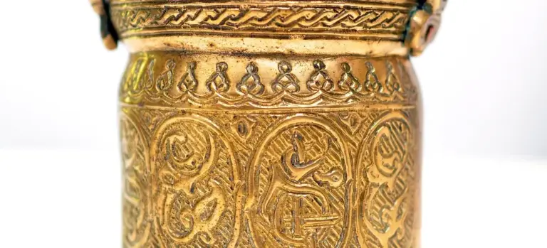 Close-up of an ornate gold urn with intricate patterns and engravings