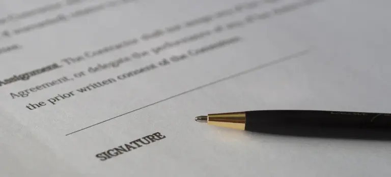 Close-up of a pen resting on a legal document with a signature line labeled SIGNATURE, symbolizing authorization for cremation.