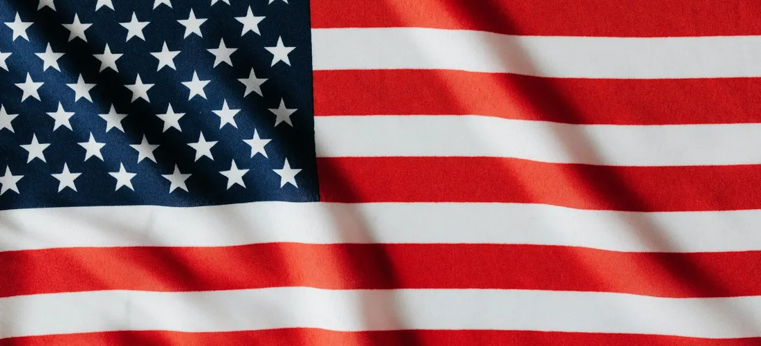 Close-up of the United States flag with stars on blue field and red and white stripes.