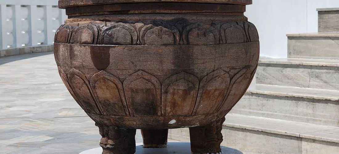 Close-up of a decorative cremation urn on a stone pedestal, symbolizing respect for personal choices in cremation arrangements